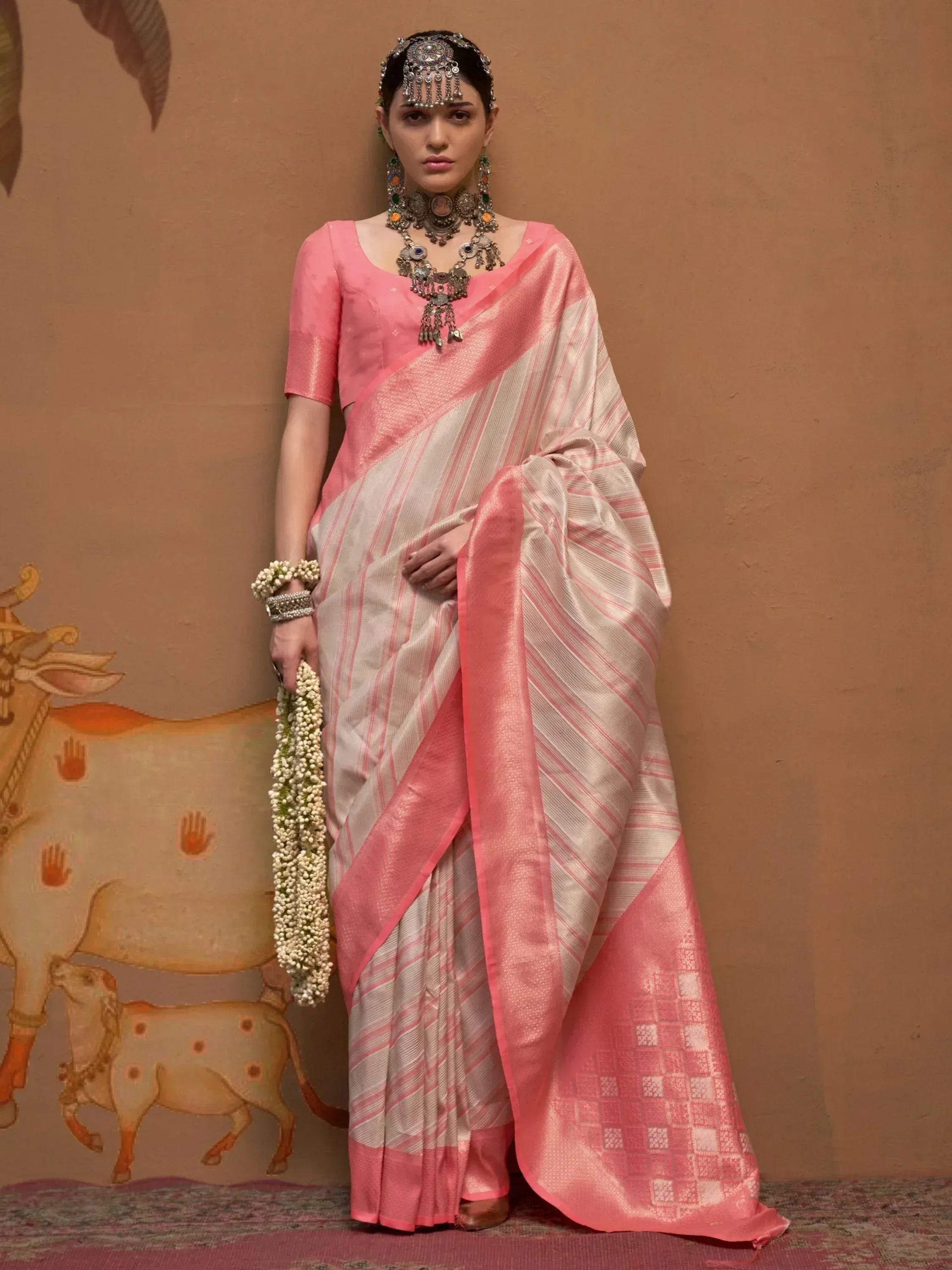 Pink and cream striped saree with traditional jewelry, perfect for Indian ethnic wear occasions