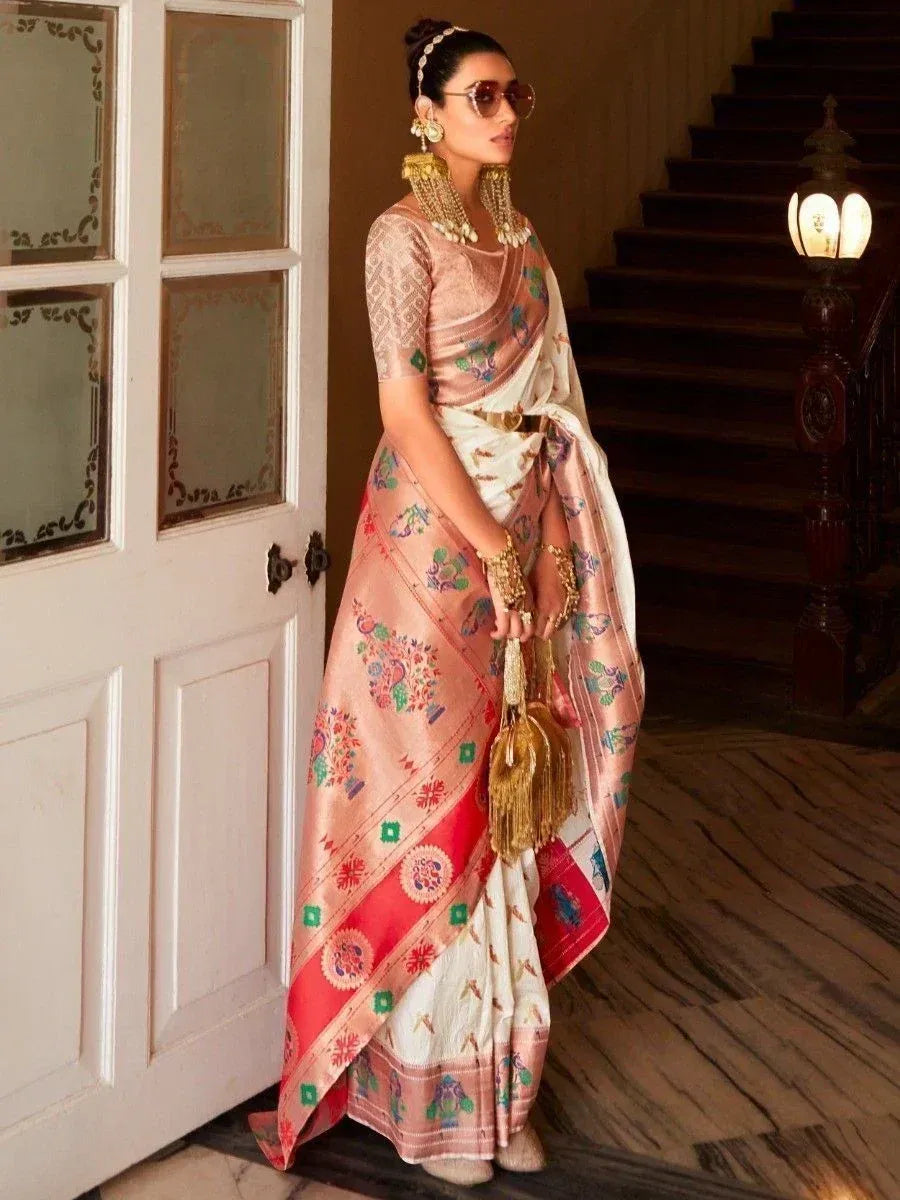 Woman in elegant Indian saree with floral print, gold jewelry, and sunglasses, styled for festive occasions