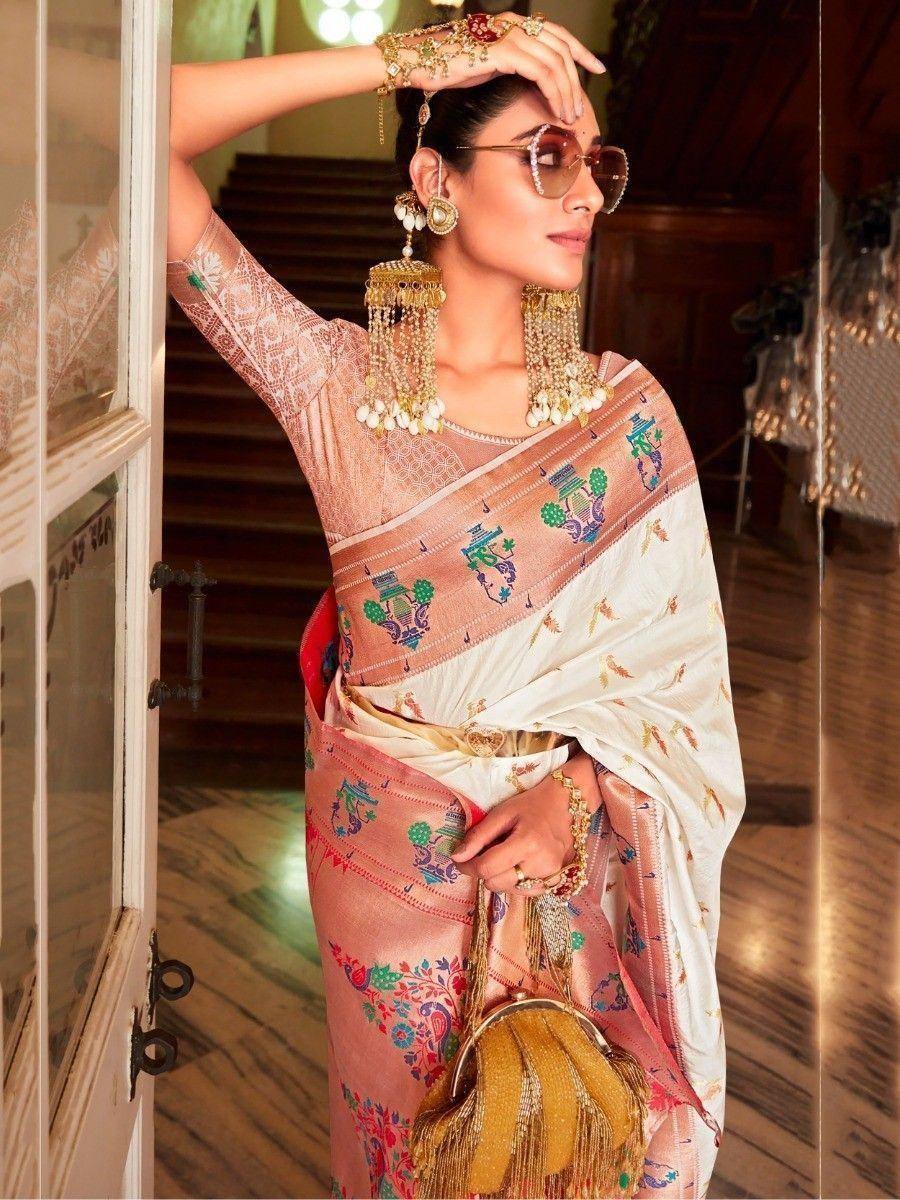 Woman in elegant embroidered saree with gold jewelry and sunglasses, showcasing Indian ethnic wear