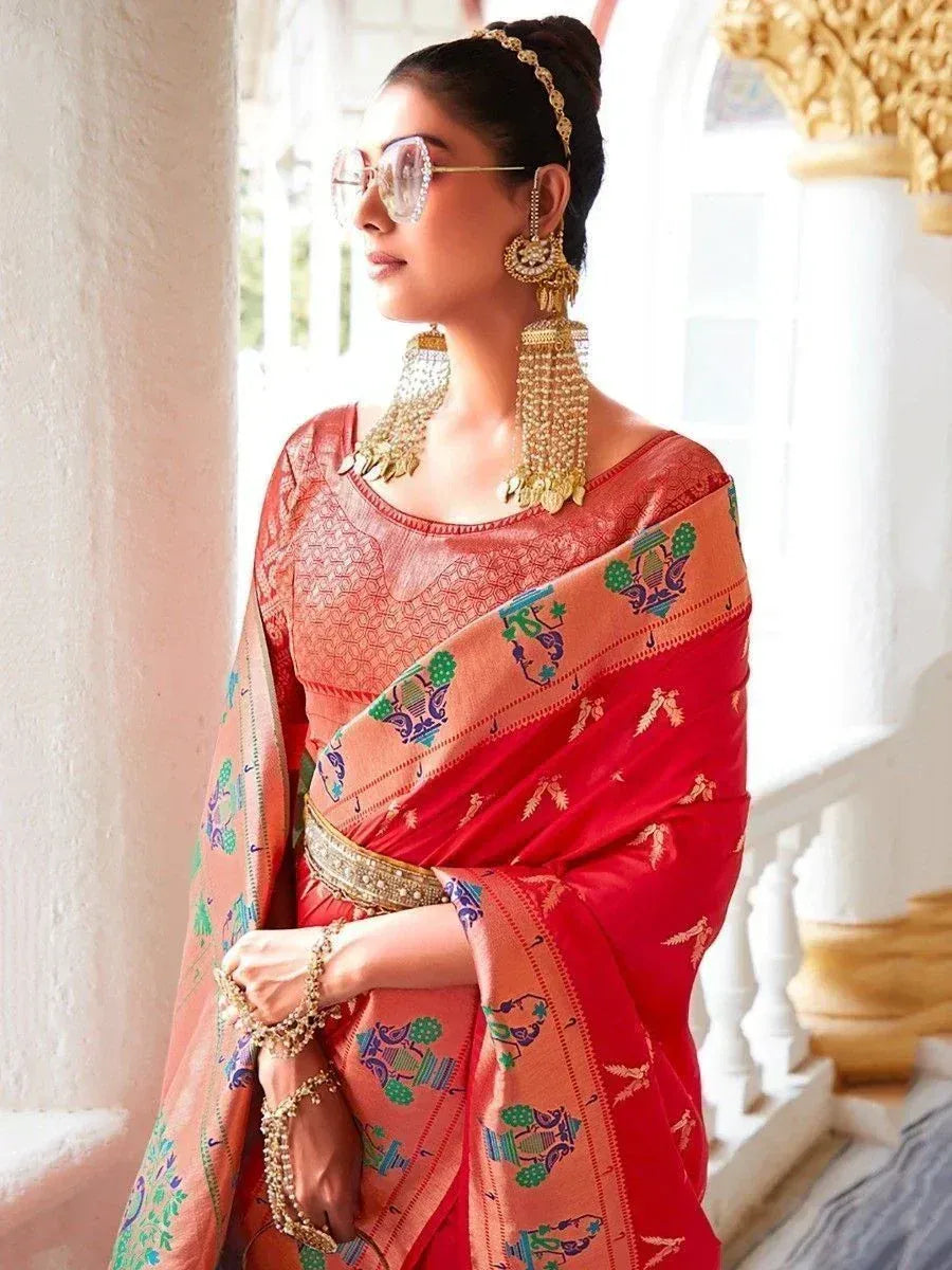 Woman in red and peach printed saree with gold jewelry, ethnic Indian wear