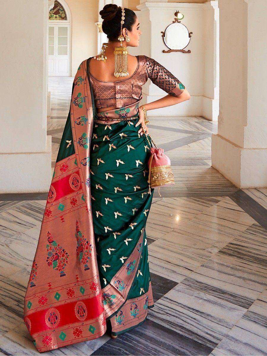 Woman in green embroidered saree with pink border, traditional Indian ethnic wear, designer blouse and jewelry