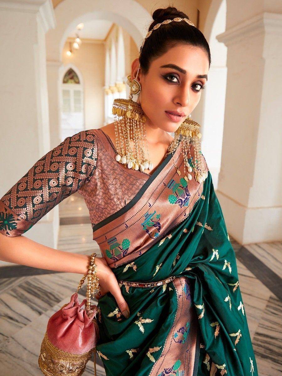 Woman in green embroidered saree with gold jewelry, traditional Indian ethnic wear