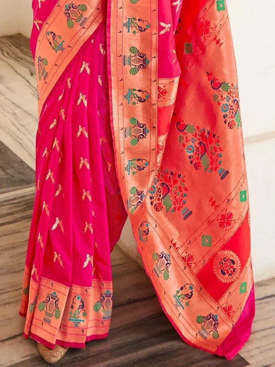 Vibrant pink and orange Indian saree with peacock and floral motifs, perfect for ethnic wear occasions.