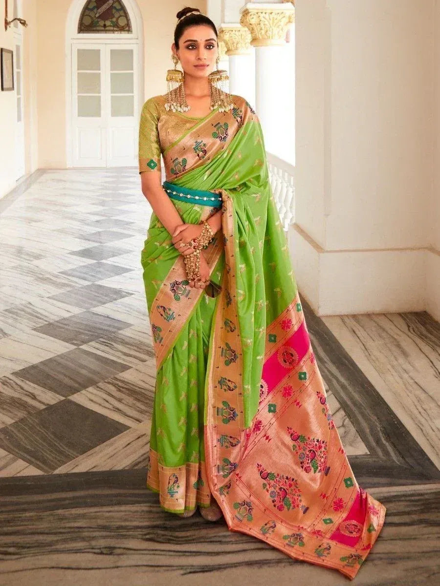 Vibrant green and peach embroidered saree with gold motifs, styled with traditional jewelry for ethnic wear