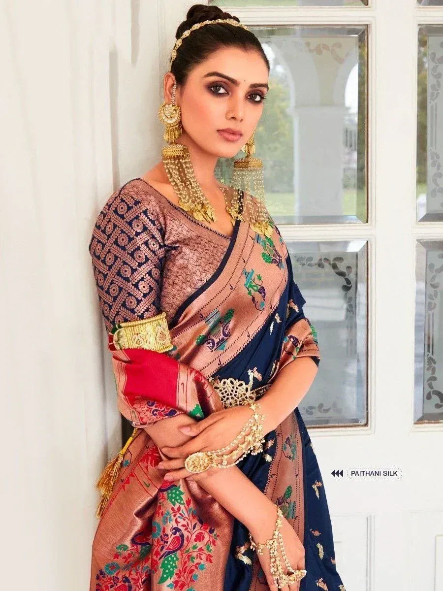 Elegant navy and peach Paithani silk saree with floral embroidery, paired with gold jewelry for traditional Indian wear
