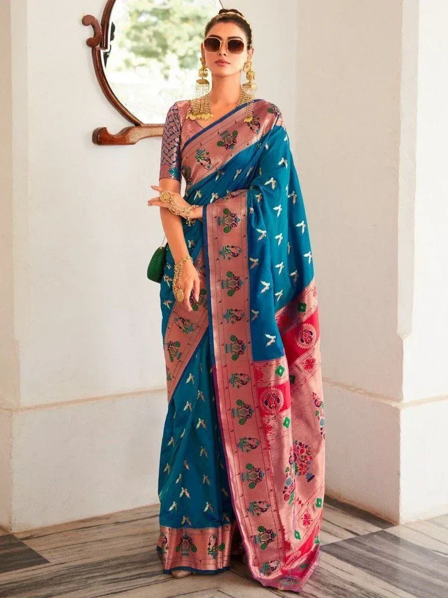 Woman in blue and pink embroidered saree with gold jewelry, stylish ethnic wear for occasions