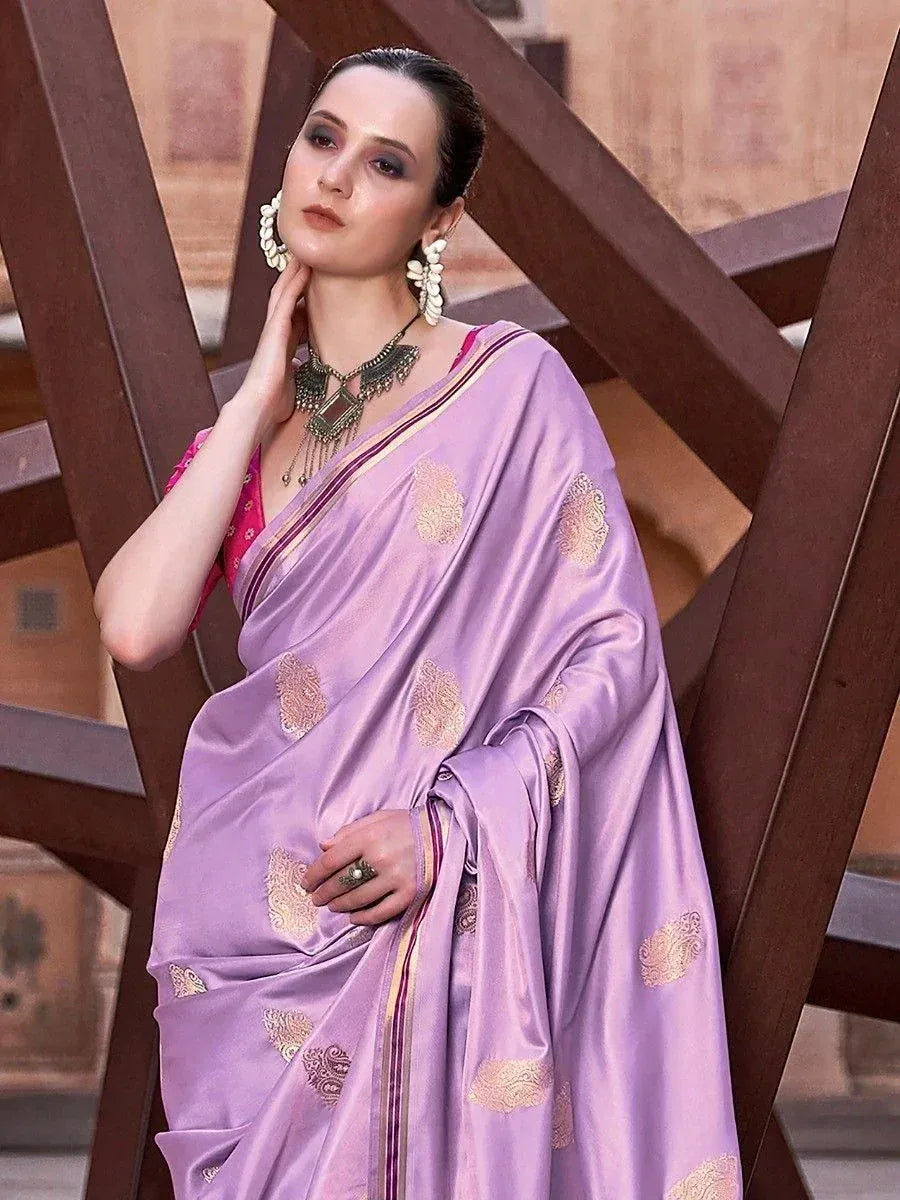 Lavender silk saree with gold paisley print, paired with pink blouse and ethnic jewelry for traditional Indian wear