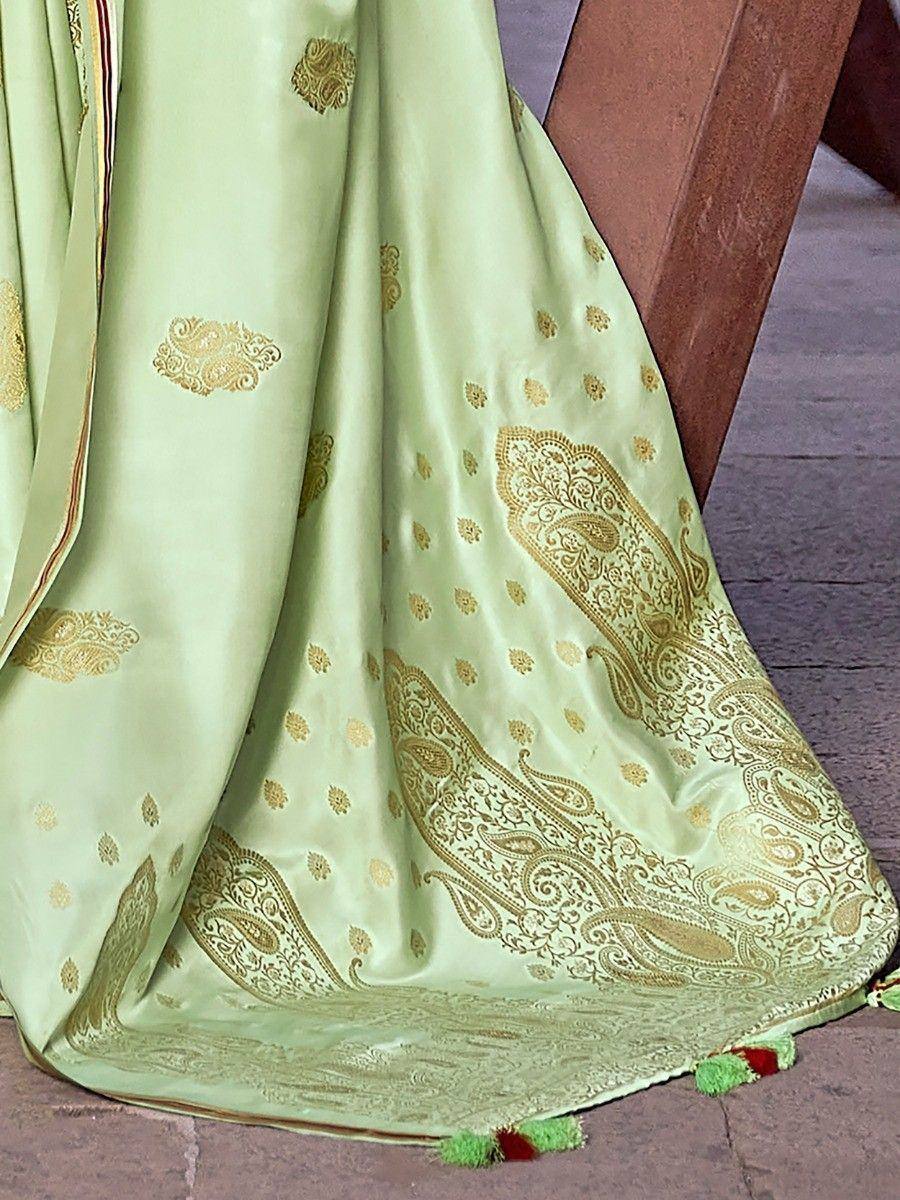 Light green saree with gold paisley embroidery and tassels, ideal for ethnic wear occasions