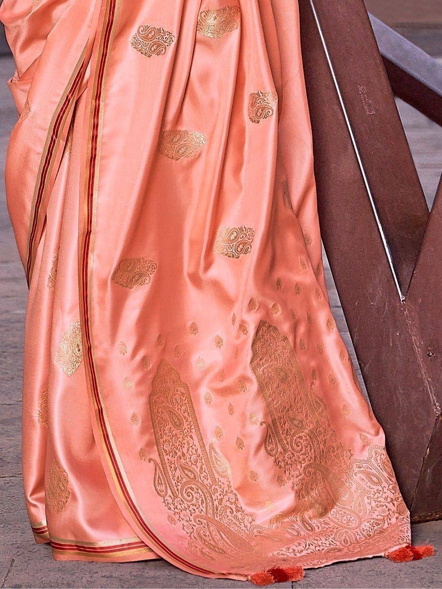 Peach silk saree with gold paisley embroidery and red border, ideal for Indian ethnic wear occasions