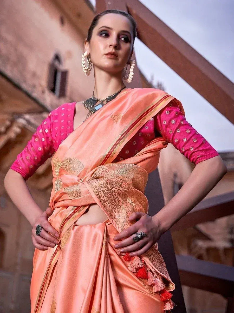 Peach silk saree with gold embroidery and pink blouse, styled with statement jewelry for ethnic occasions