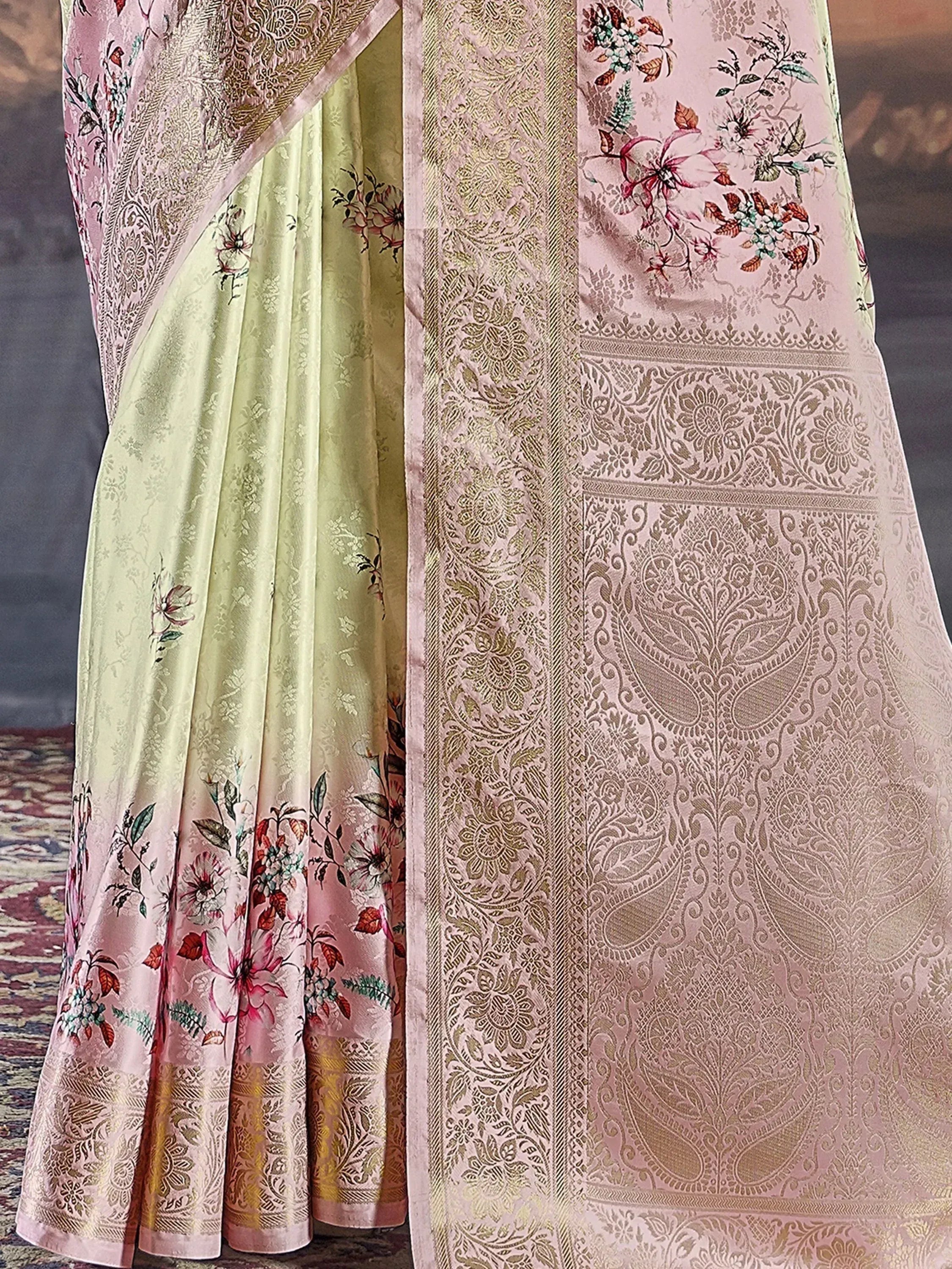 Elegant pink and green floral saree with intricate gold zari work, perfect for Indian ethnic occasions.