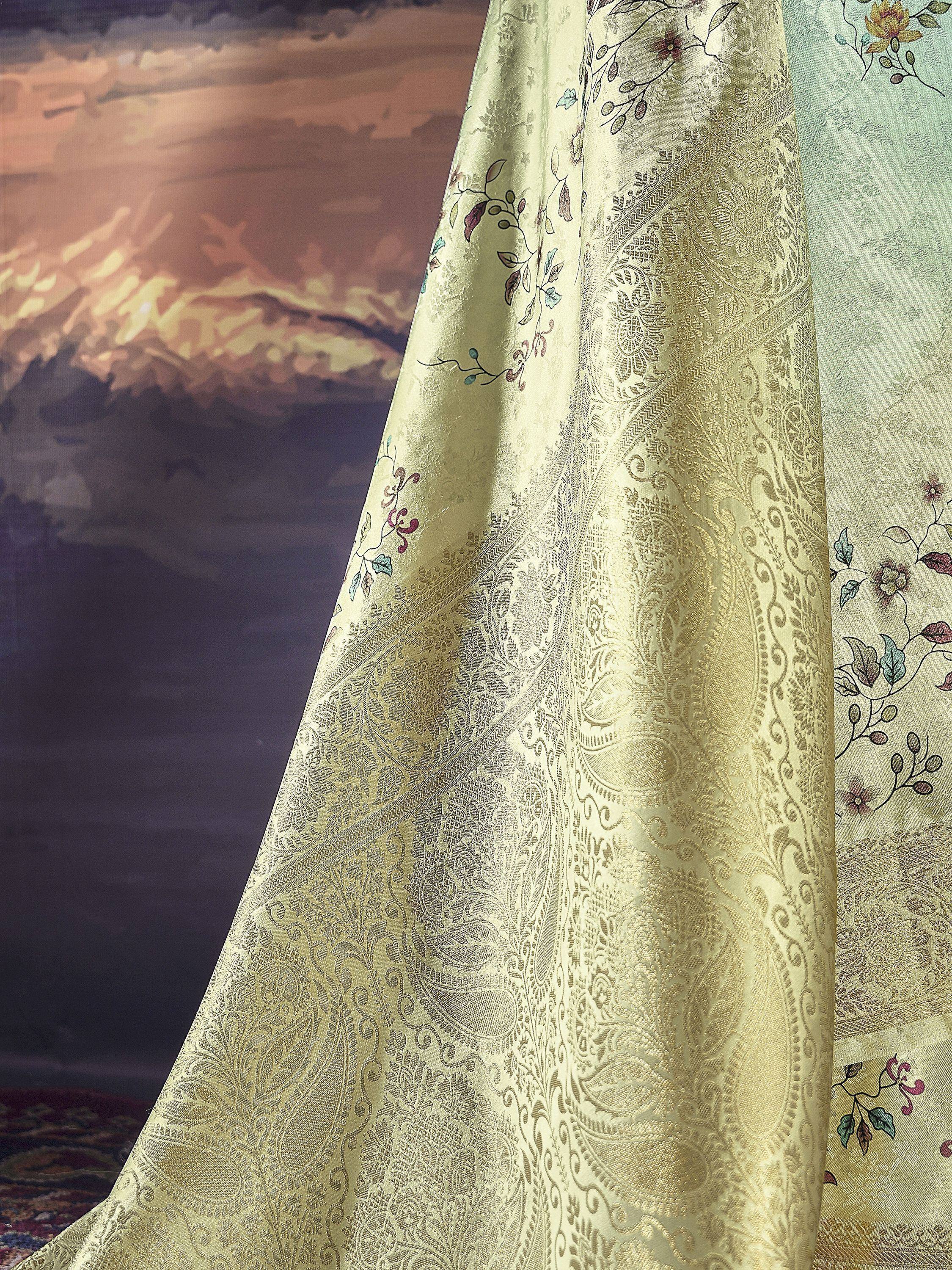 Elegant gold paisley saree with floral embroidery, perfect for Indian ethnic wear occasions.
