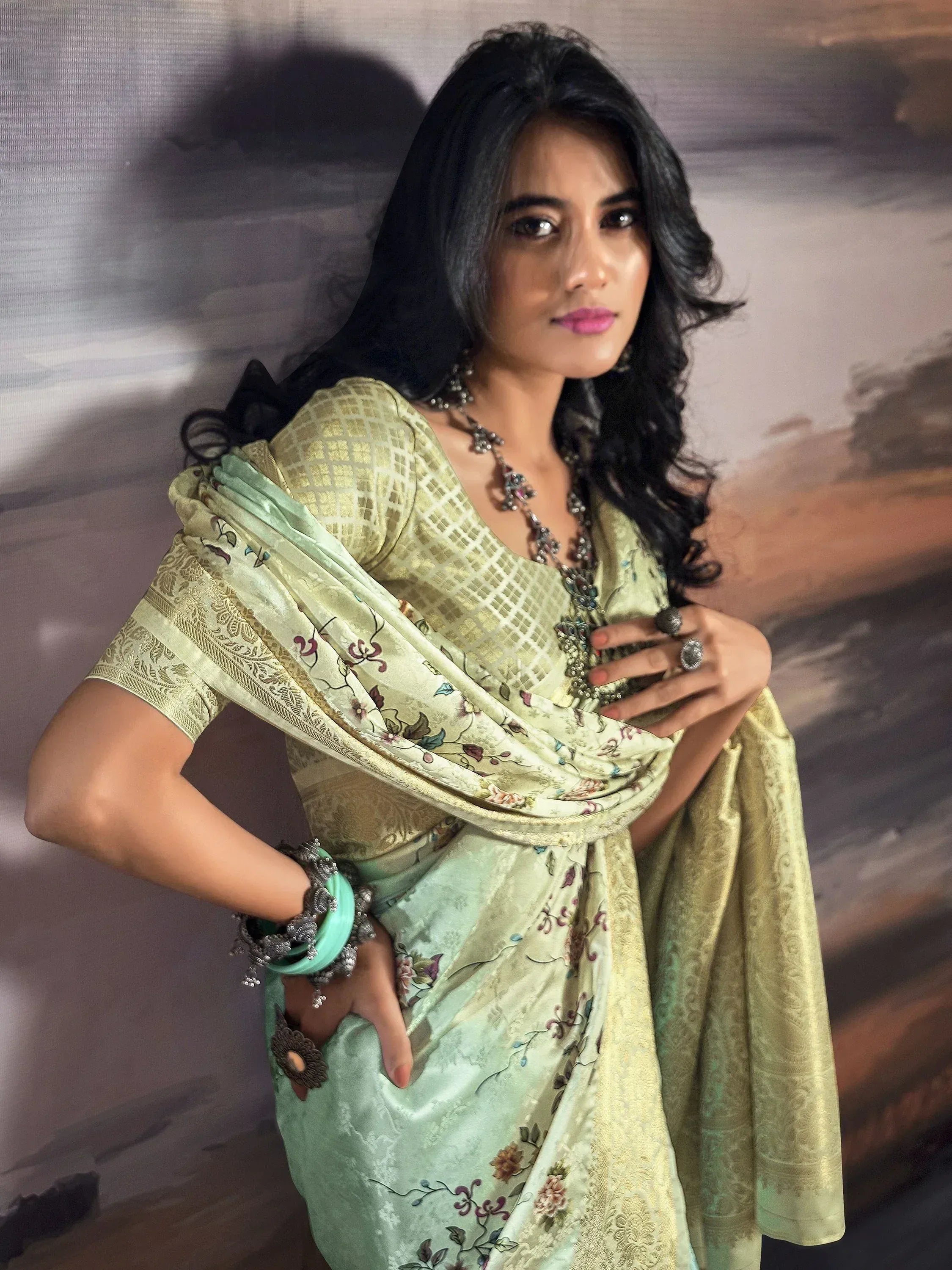 Woman in elegant green floral saree with gold blouse, traditional Indian ethnic wear