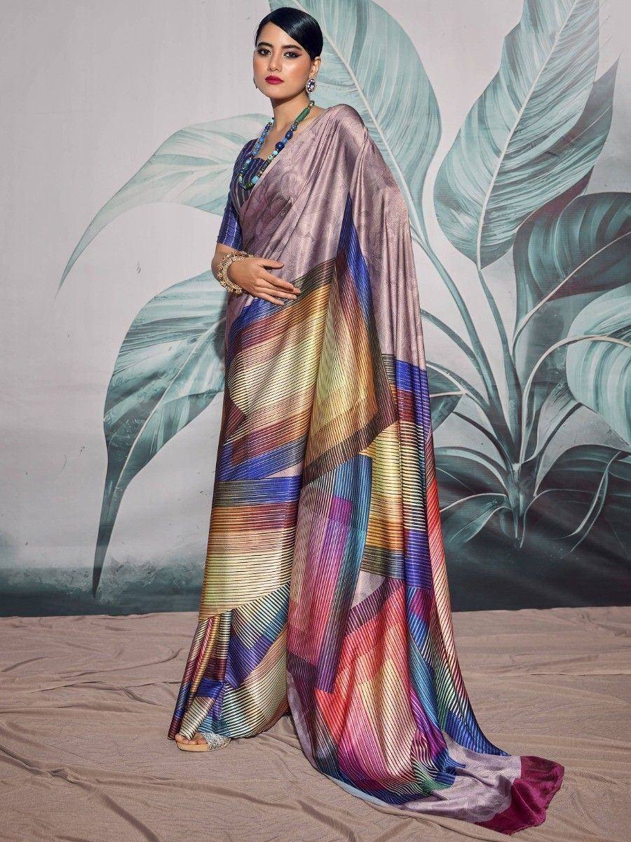 Woman in vibrant multicolor saree with geometric print, styled with statement jewelry for ethnic occasions