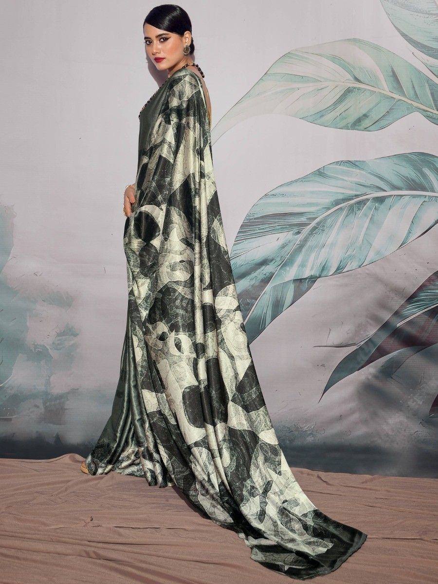 Woman in elegant green and black printed saree with abstract pattern, perfect for ethnic occasions.