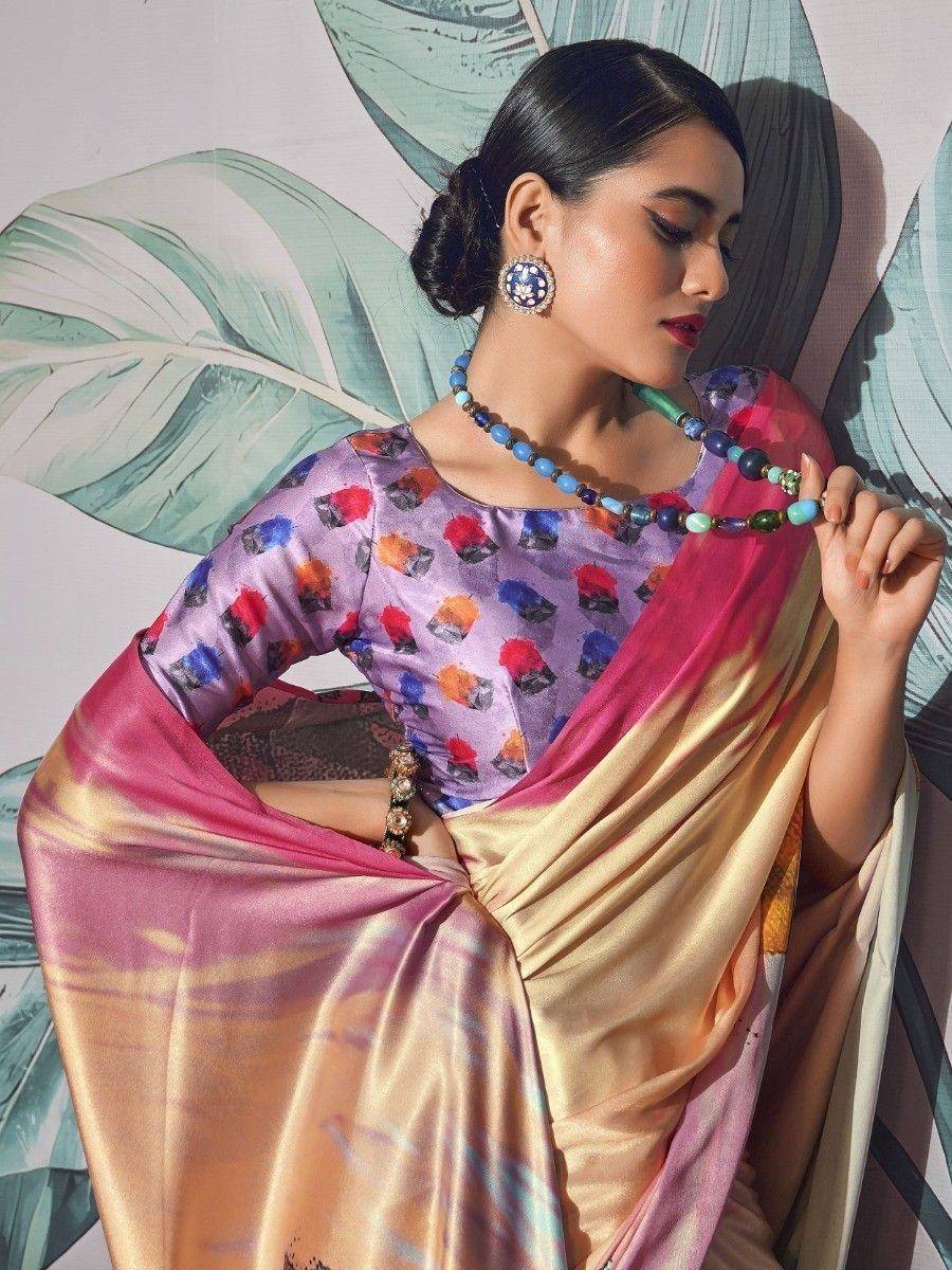 Woman in colorful printed saree with pink and gold border, styled with statement jewelry for ethnic wear