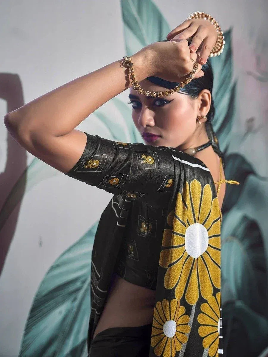 Woman in black and gold floral ethnic saree with designer blouse, styled with traditional jewelry