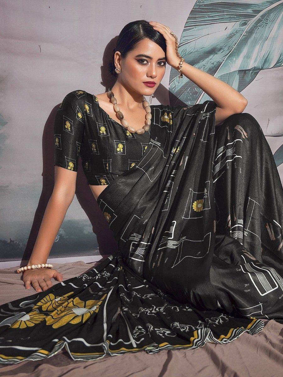 Black printed saree with yellow floral motifs and geometric patterns, paired with matching blouse for ethnic wear