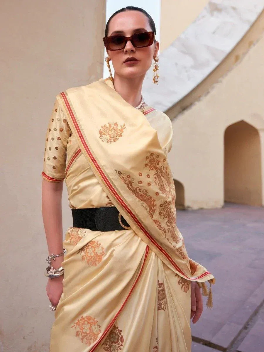 Cream floral saree with red border, styled with black belt and sunglasses for modern ethnic look