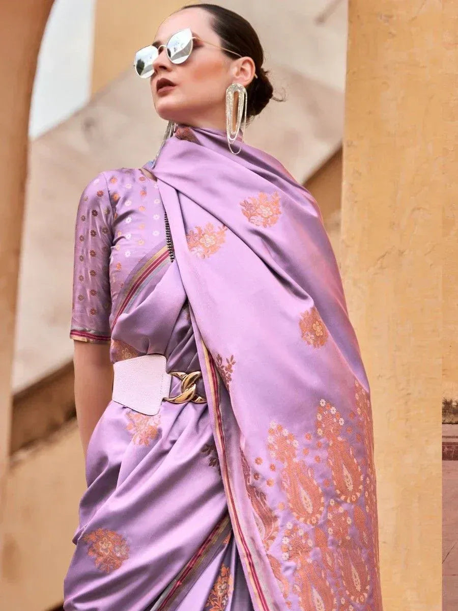 Lavender silk saree with gold floral print, styled with belt and statement earrings for ethnic wear