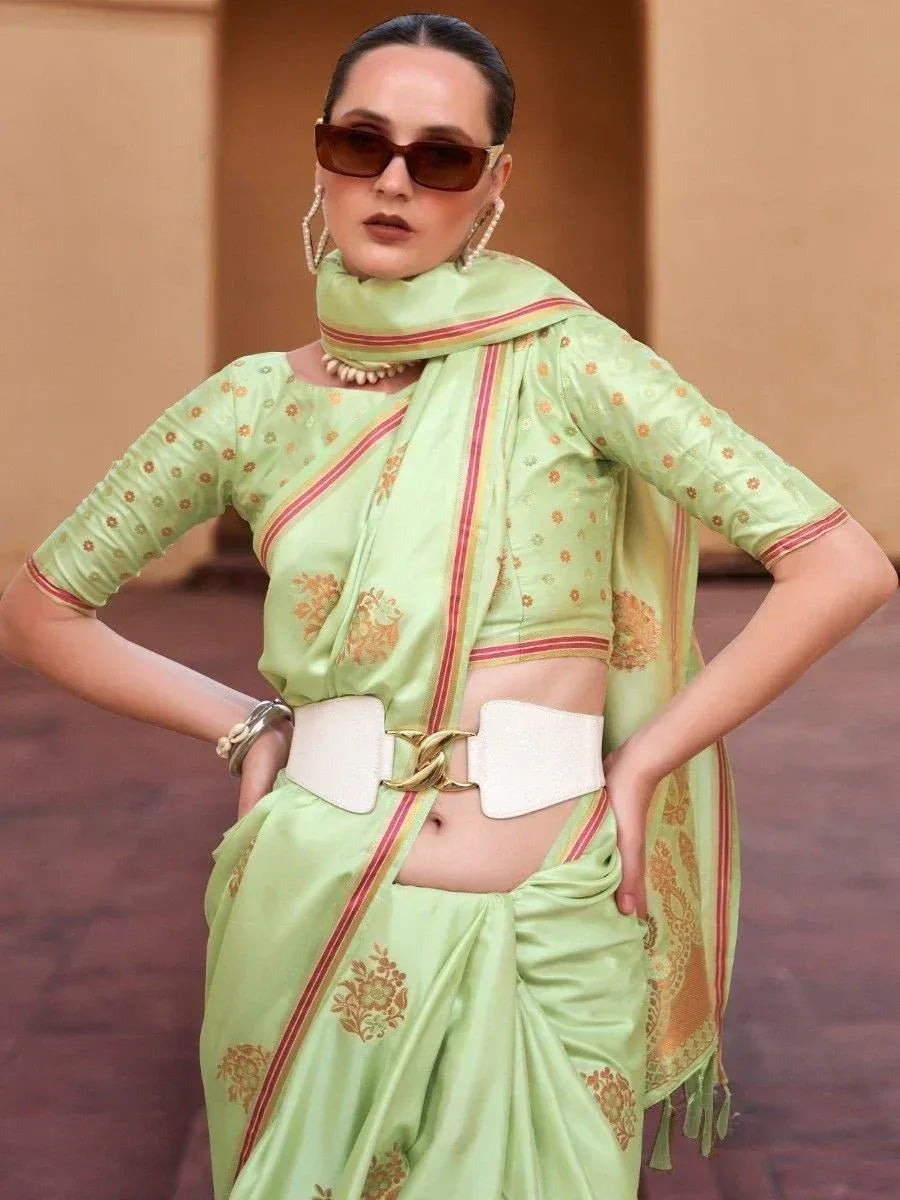 Stylish light green saree with gold floral print, red border, and white belt for modern ethnic look