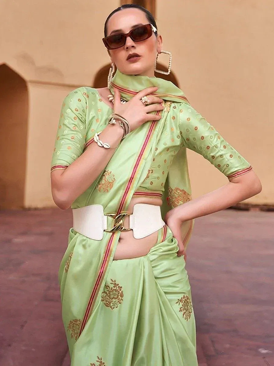 Stylish mint green saree with gold floral print, modern belt, and statement earrings for ethnic wear