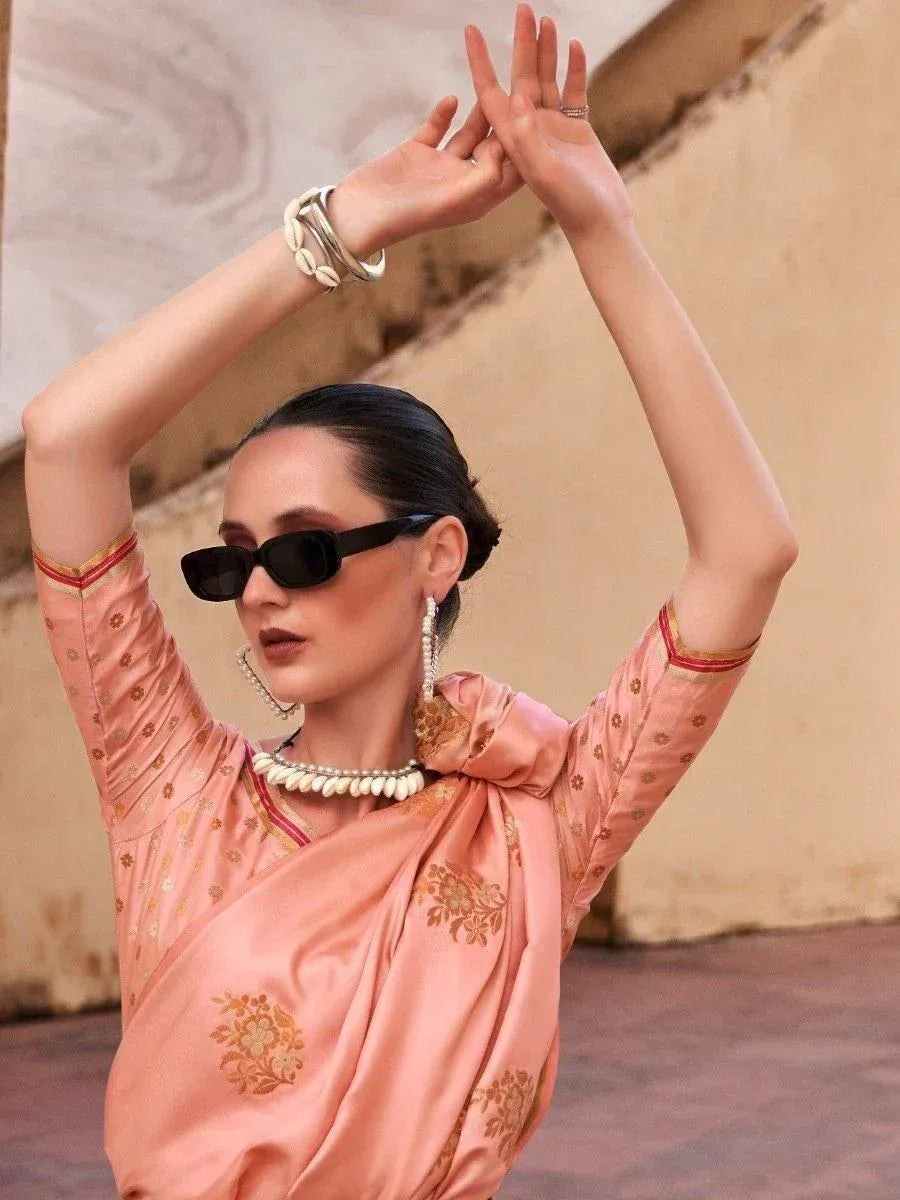 Woman in peach ethnic gown with gold embroidery, styled with sunglasses and shell jewelry