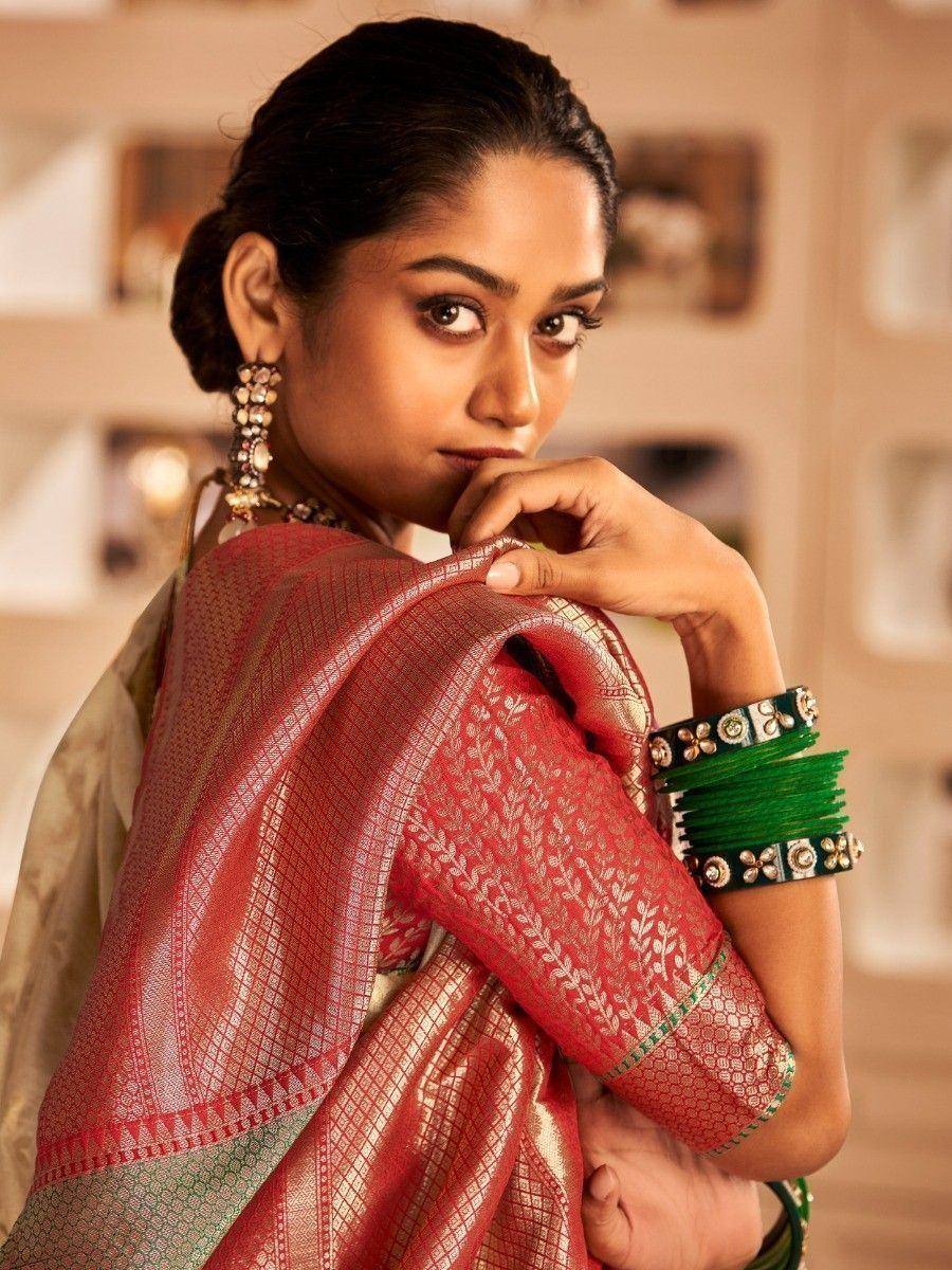 Woman in red and gold designer saree with green bangles, ethnic Indian wear