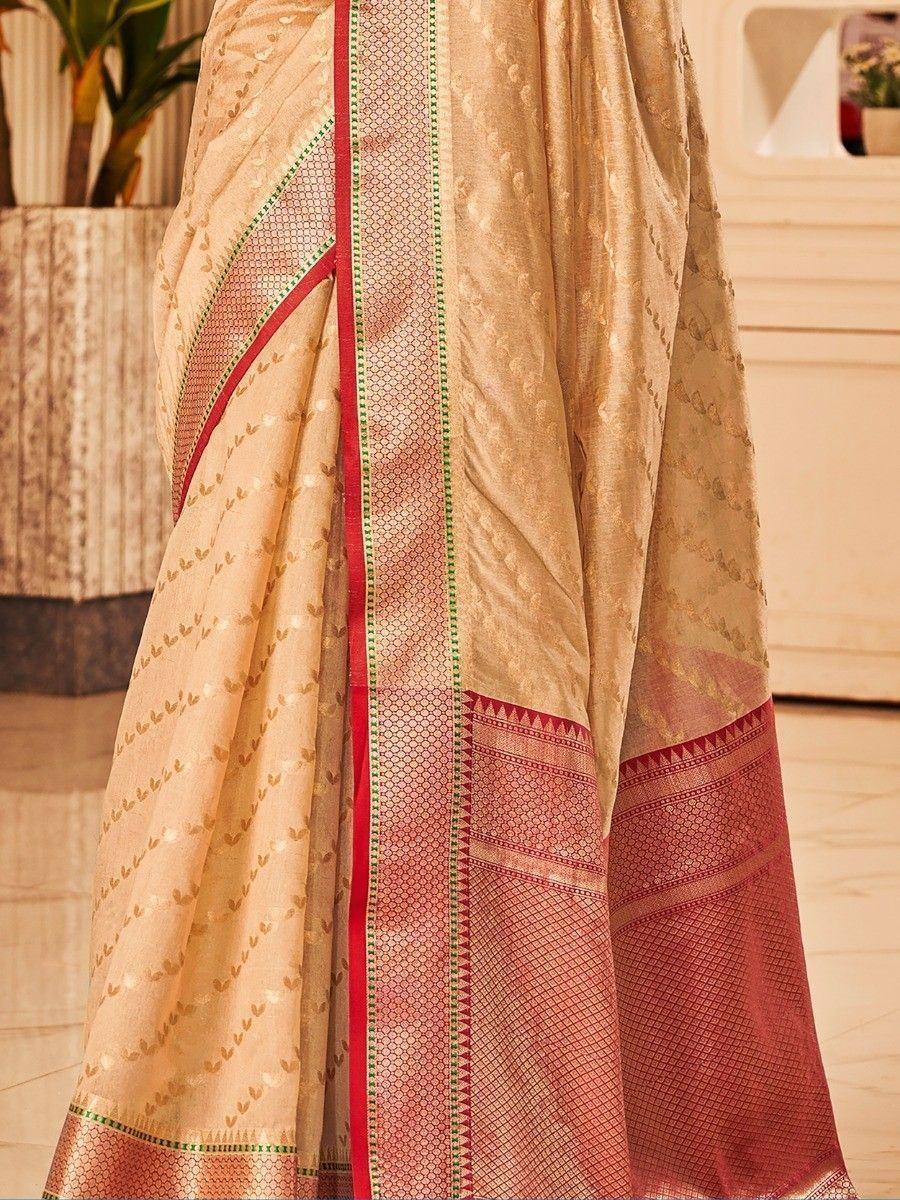 Beige and red designer saree with gold leaf print and geometric border, ideal for ethnic wear occasions.