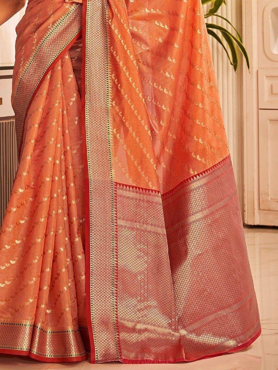 Orange designer saree with gold motifs and intricate border, perfect for ethnic occasions