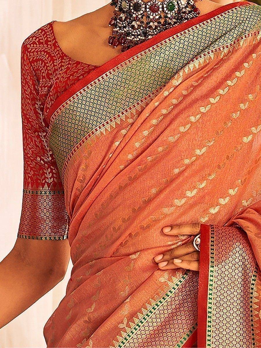 Orange printed saree with red blouse and intricate border, styled with traditional jewelry for ethnic wear