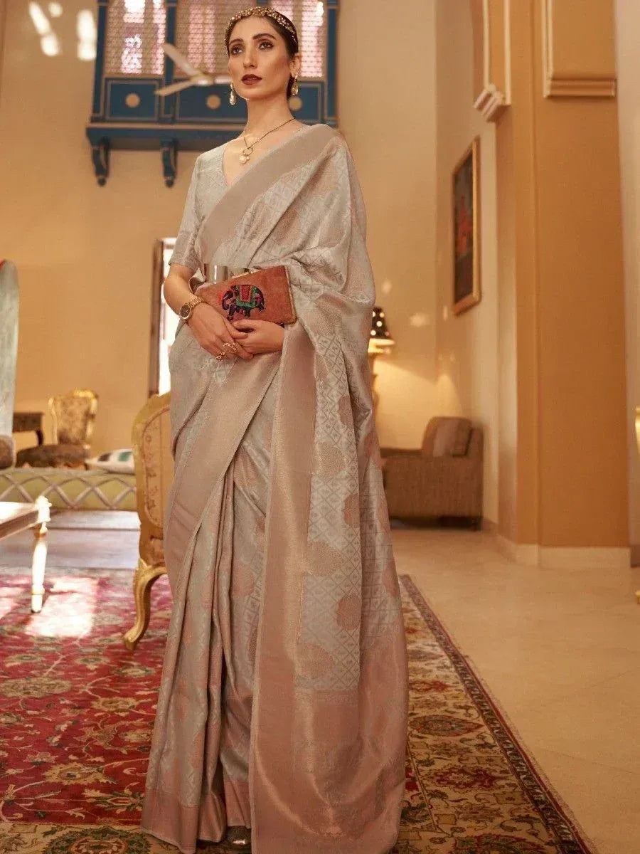 Elegant beige designer saree with intricate patterns, perfect for Indian ethnic wear occasions