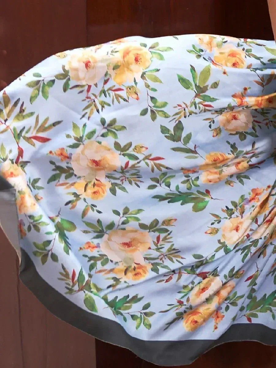 Light blue floral print ethnic gown with yellow roses and green leaves, perfect for Indian occasions