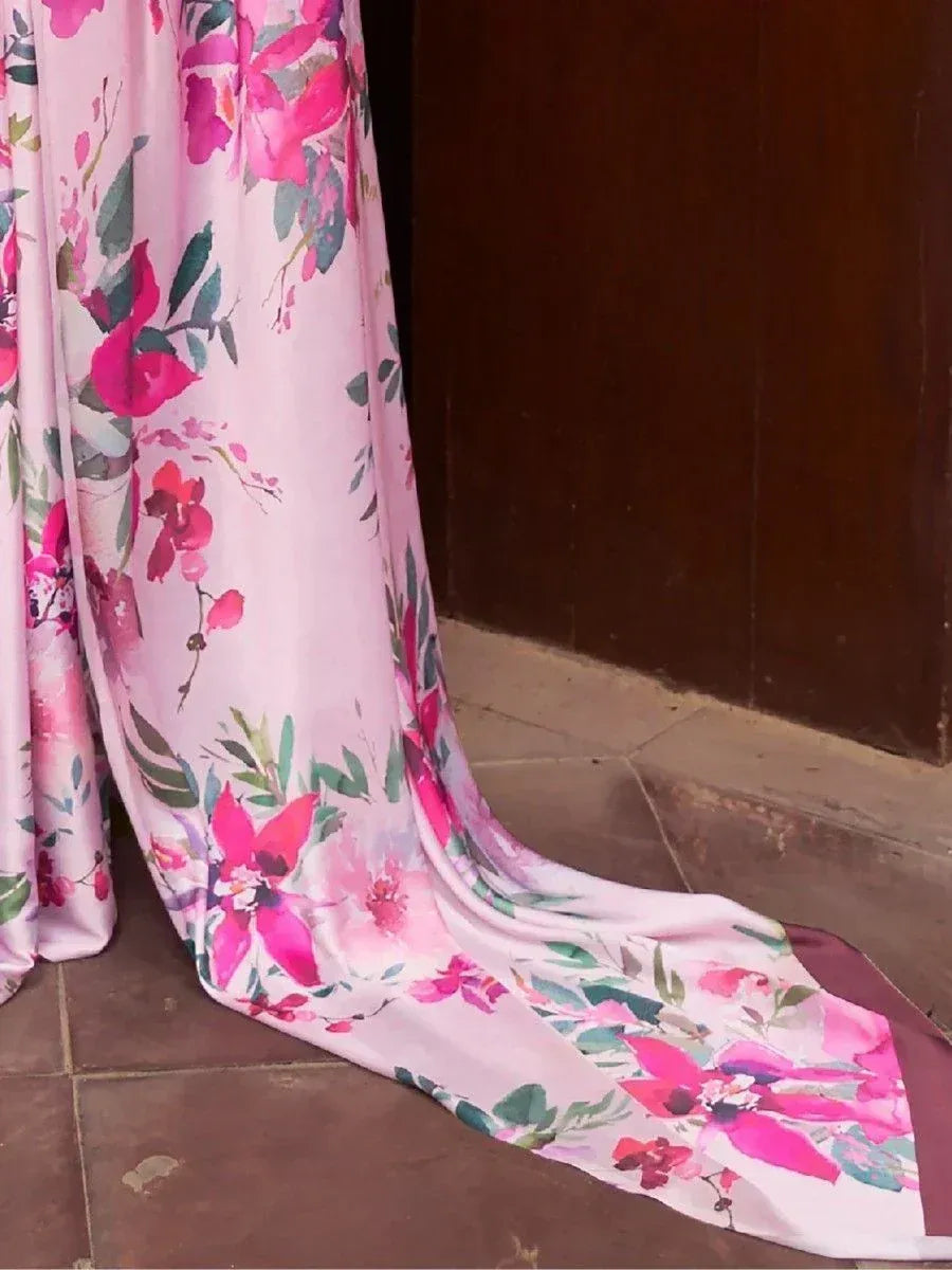 Pink floral ethnic gown with vibrant blooms and green leaves, flowing elegantly on tiled floor
