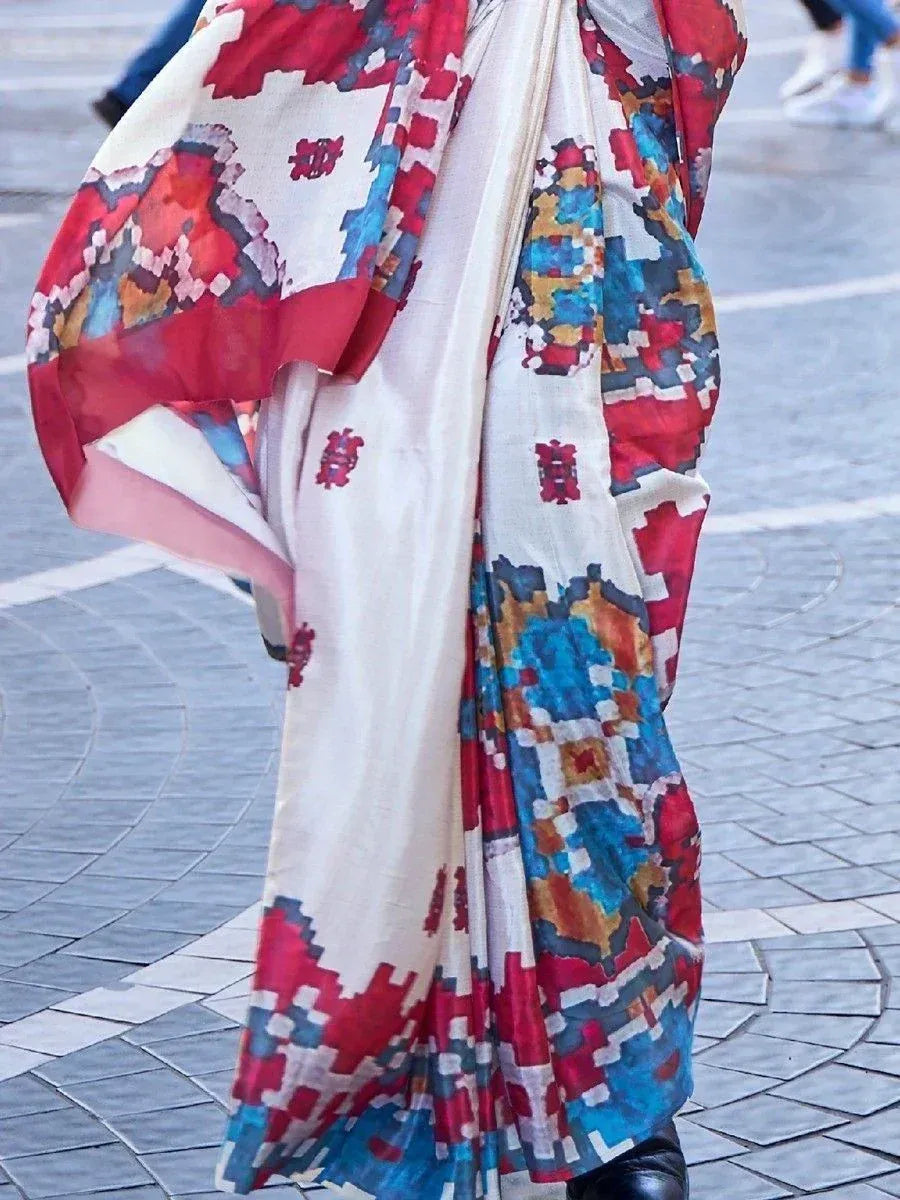Vibrant geometric print ethnic saree with red, blue, and cream hues, perfect for festive occasions.