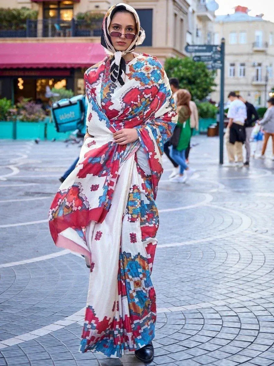Woman wearing colorful printed saree with matching headscarf, walking on city street