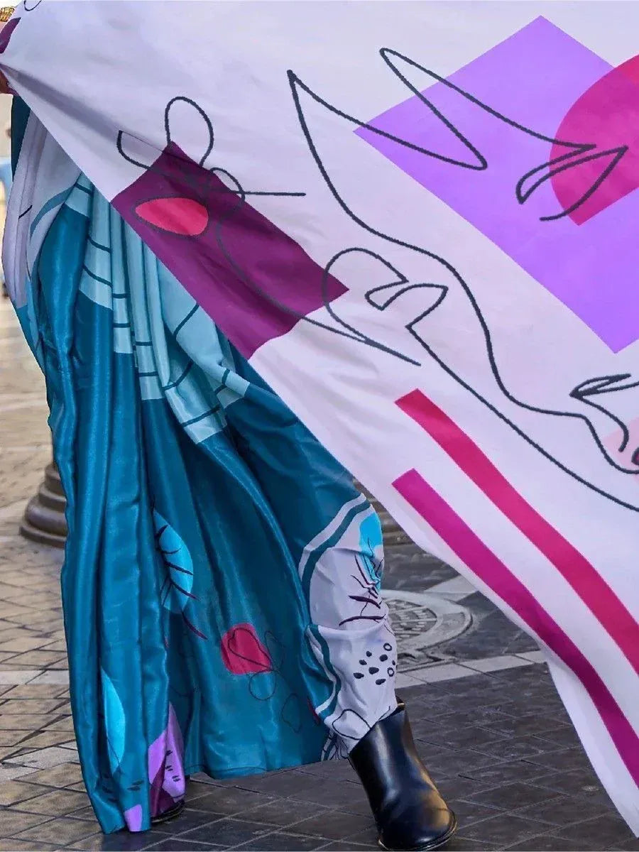 Teal printed saree with abstract art pallu, paired with black boots for modern ethnic look