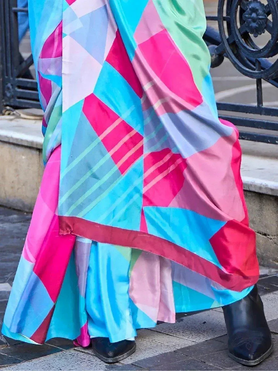 Vibrant geometric print saree in pink, blue, and green, styled with black boots for modern ethnic wear.