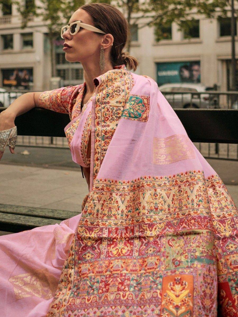 Woman in vibrant pink ethnic gown with intricate floral embroidery, perfect for Indian festive occasions.