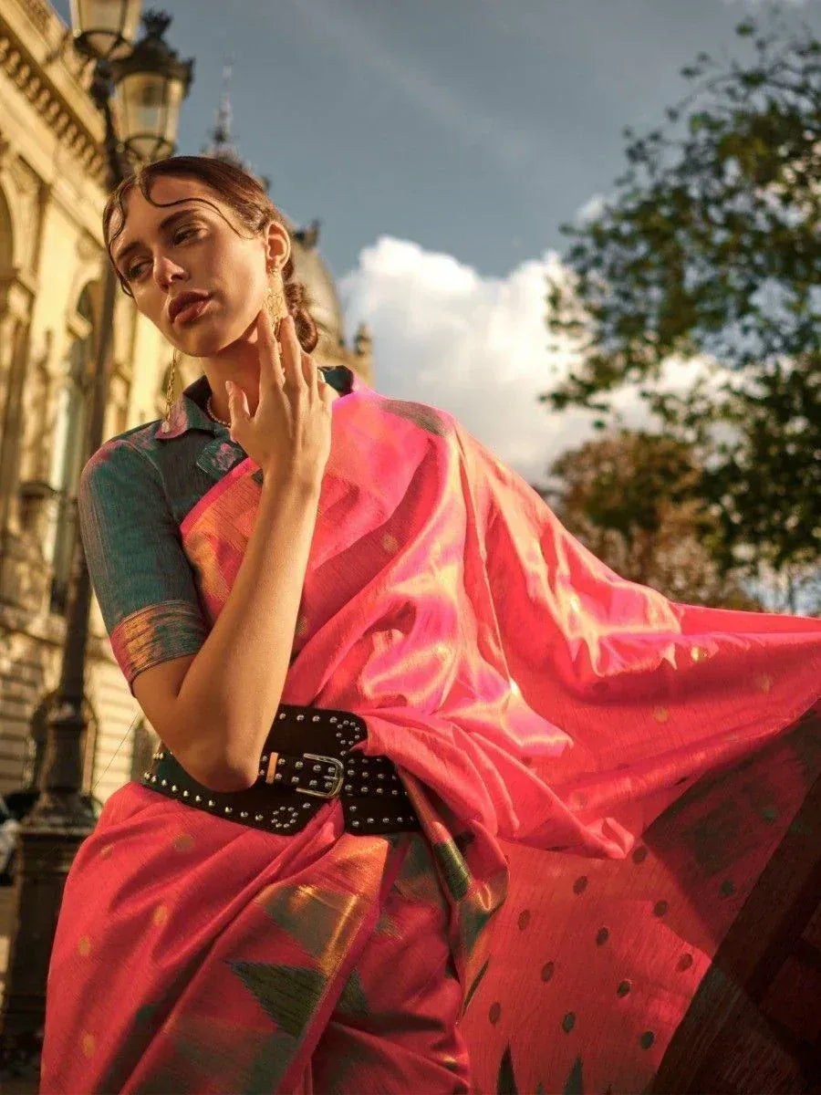 Vibrant pink silk saree with gold motifs, styled with studded belt and green blouse, perfect for ethnic occasions