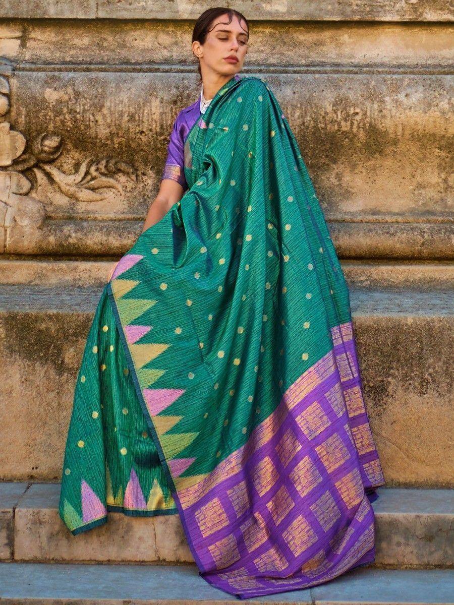 Green and purple ethnic saree with gold dots and geometric border, styled with matching blouse