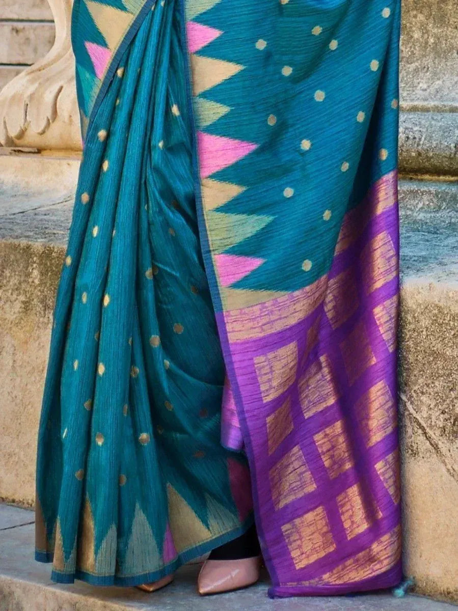 Teal and purple ethnic saree with geometric patterns and gold dots, styled for Indian occasions