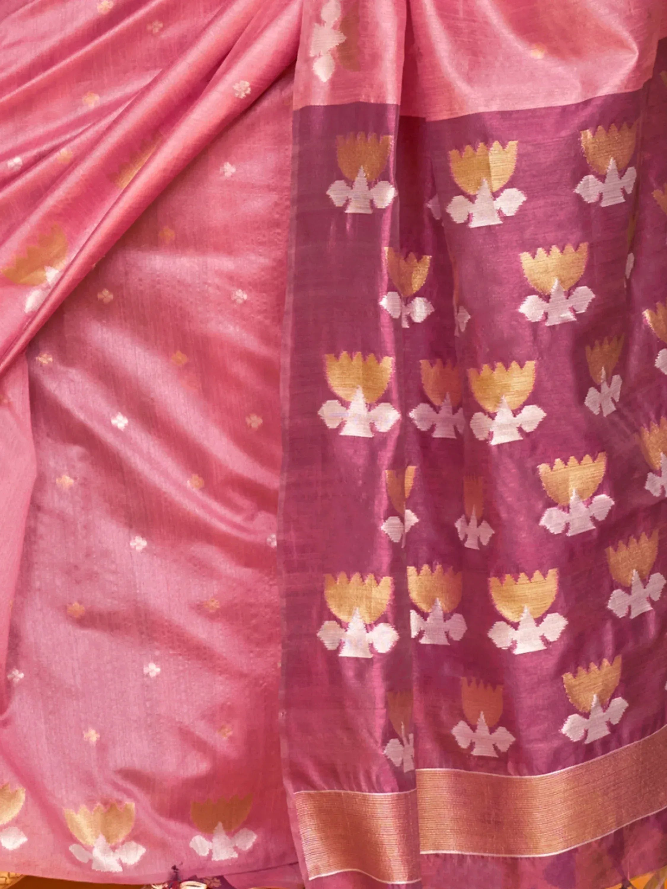 Pink ethnic saree with gold and white floral motifs, perfect for Indian occasions