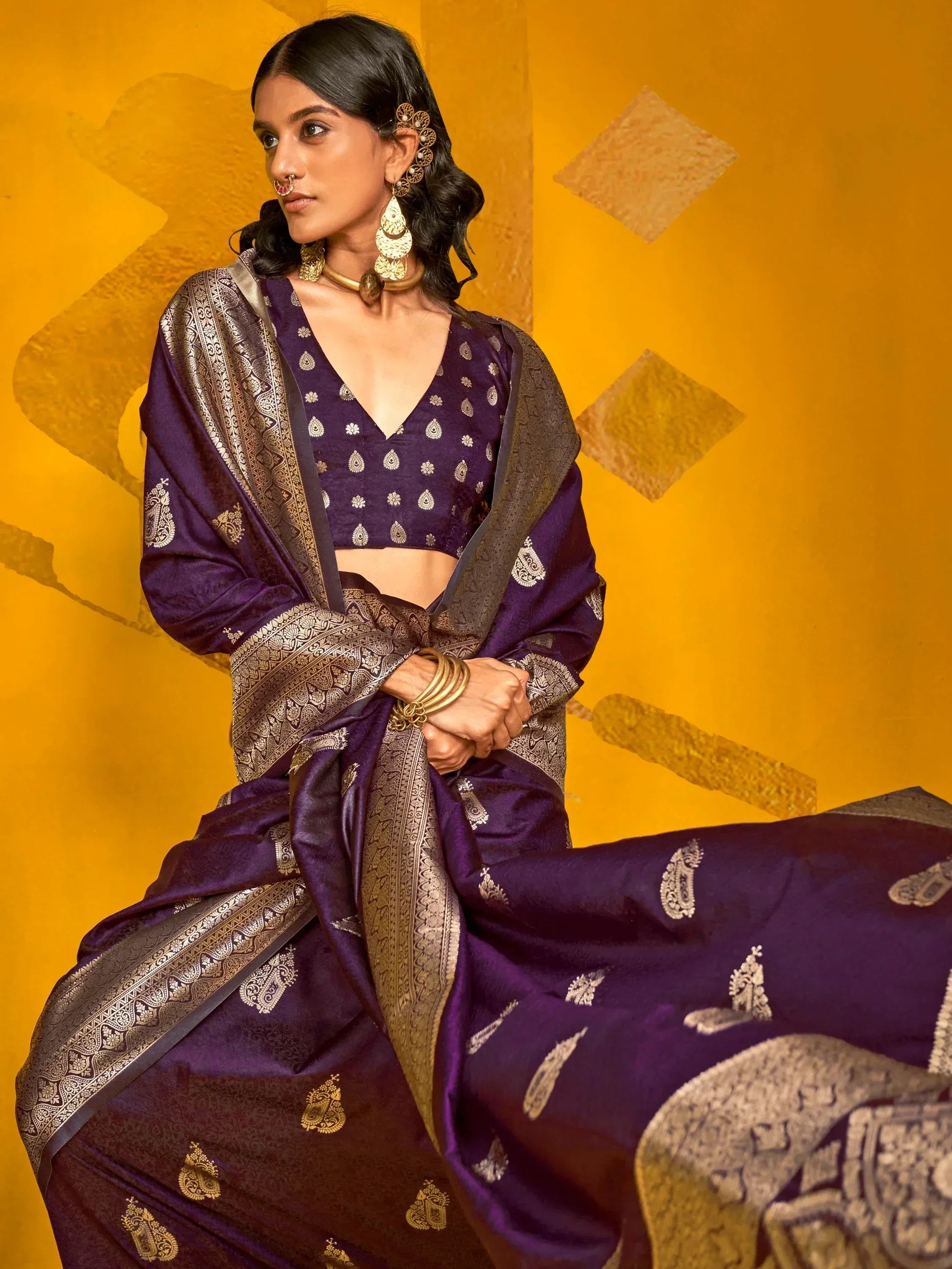 Purple designer saree with gold paisley print and border, paired with matching blouse for ethnic wear