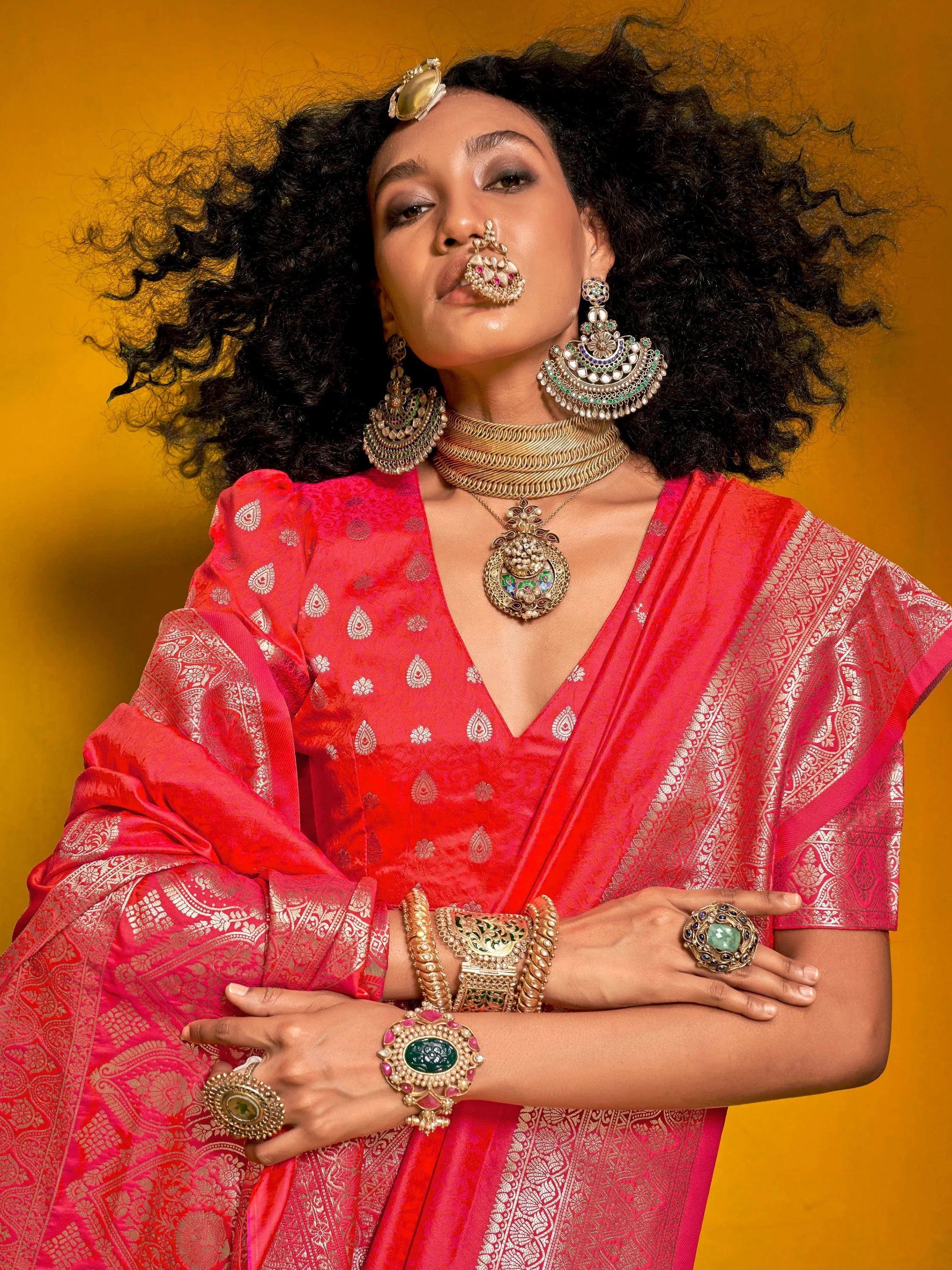 Woman in vibrant pink ethnic saree with gold jewelry, traditional Indian attire for festive occasions