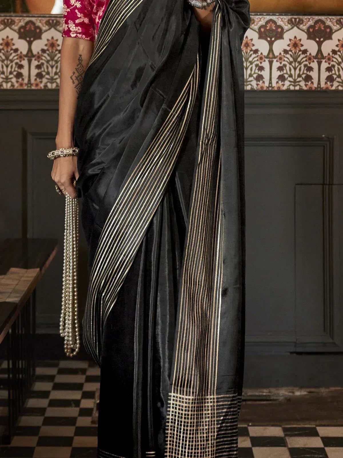 Black saree with gold stripes, paired with pink blouse, ethnic Indian wear for women