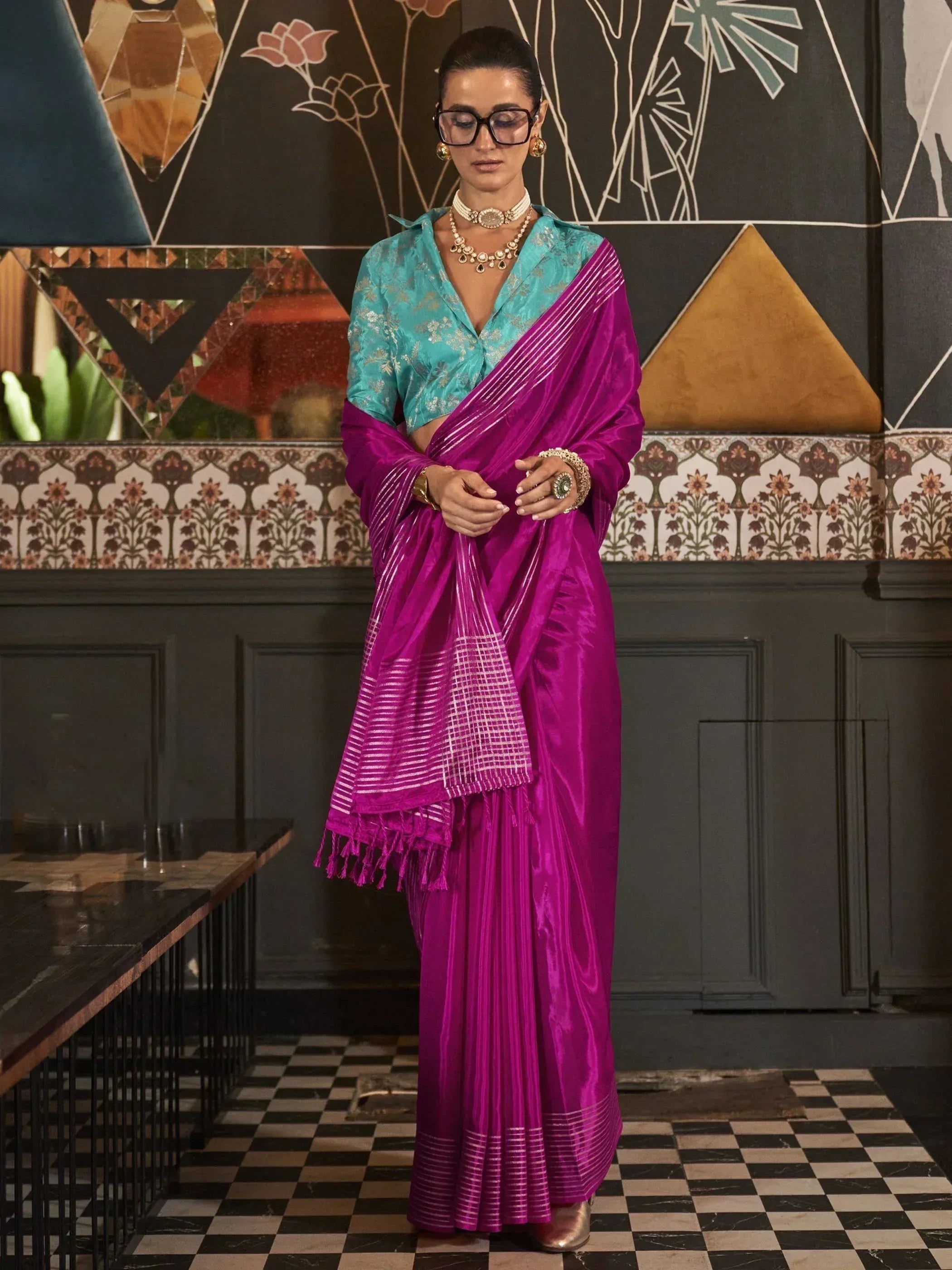 Vibrant magenta saree with silver stripes paired with turquoise embroidered blouse, elegant ethnic wear for women