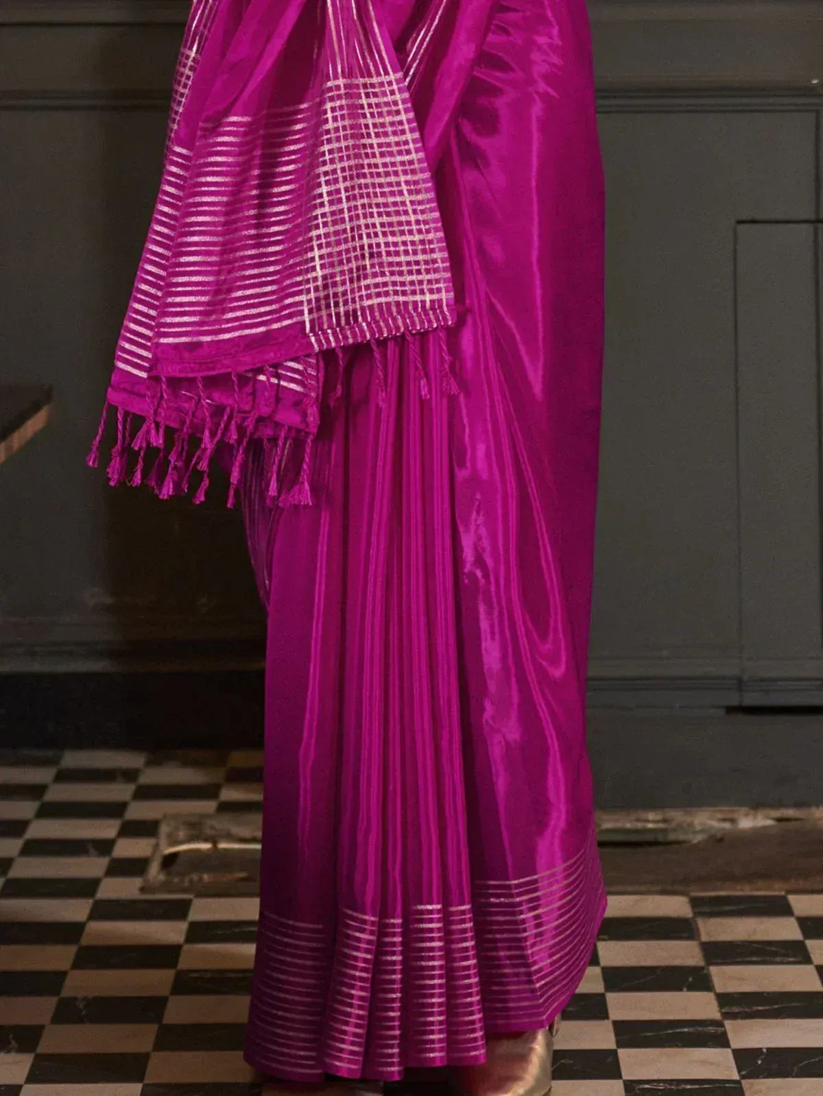 Vibrant magenta saree with silver stripes and tassels, perfect for ethnic wear occasions.