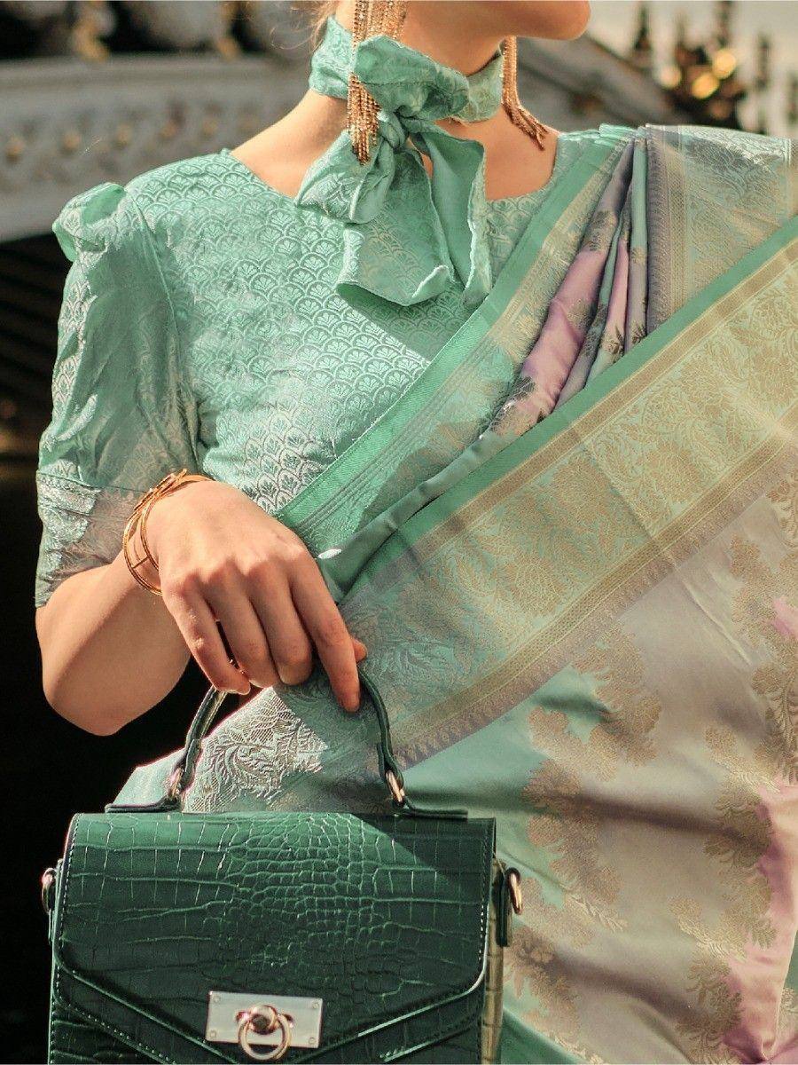 Mint green designer saree with gold embroidery, puff sleeves, and matching handbag for ethnic wear