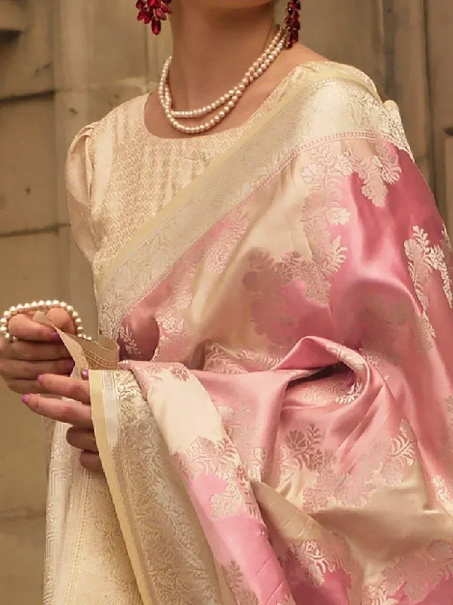 Pink and cream designer saree with floral embroidery, paired with pearl jewelry for ethnic wear
